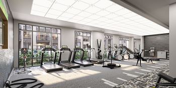 a gym with cardio equipment and large windows in a building at Link Apartments® Broad Ave, Memphis, 38112